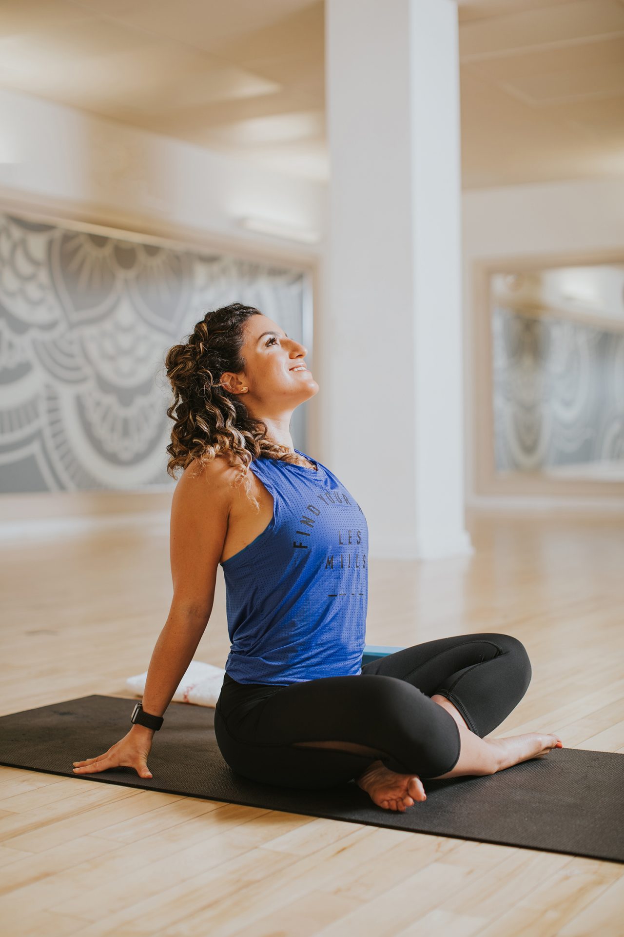 A person practicing yoga in a GoodLife Fitness studio