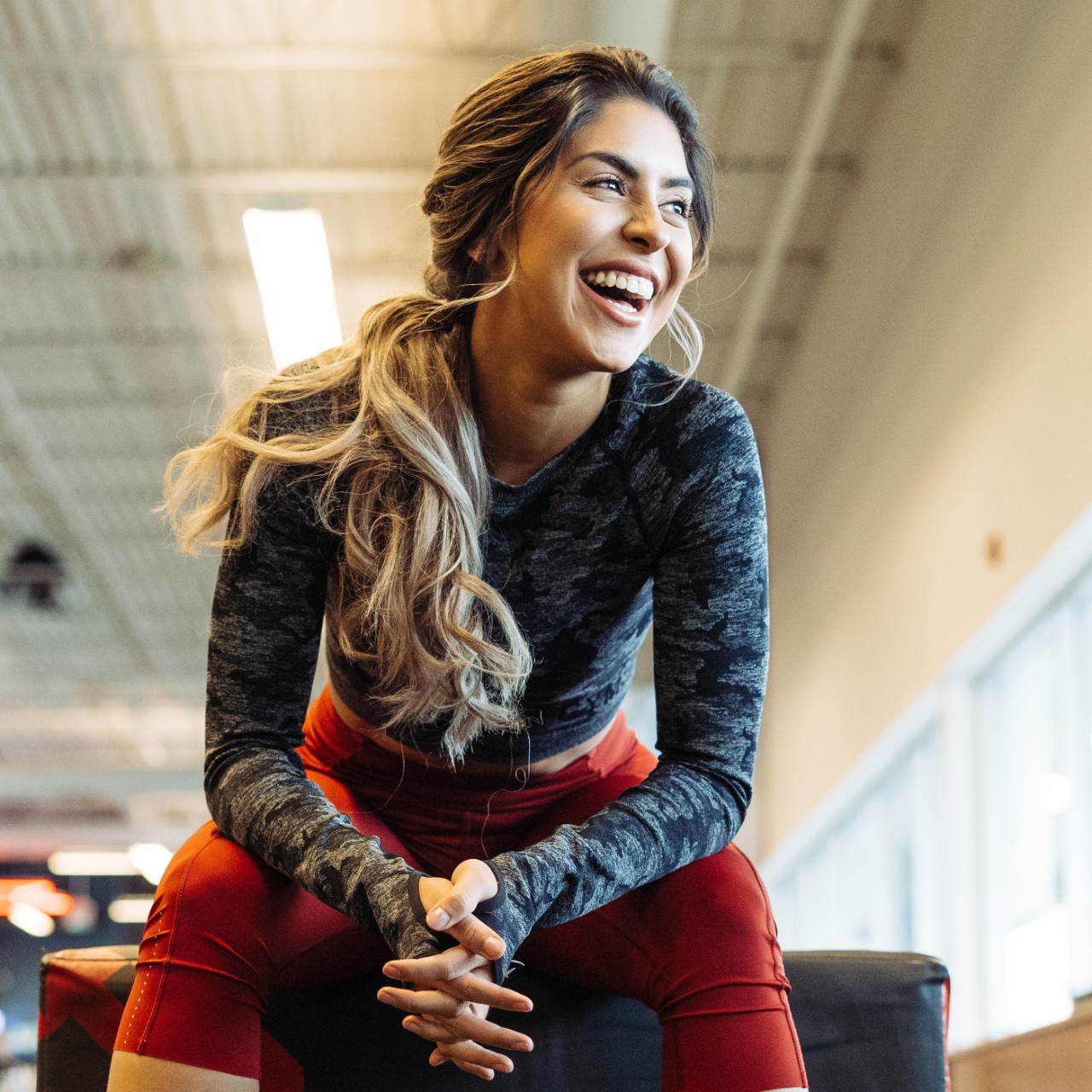 A person sitting on box jump inside a GoodLife Fitness Club